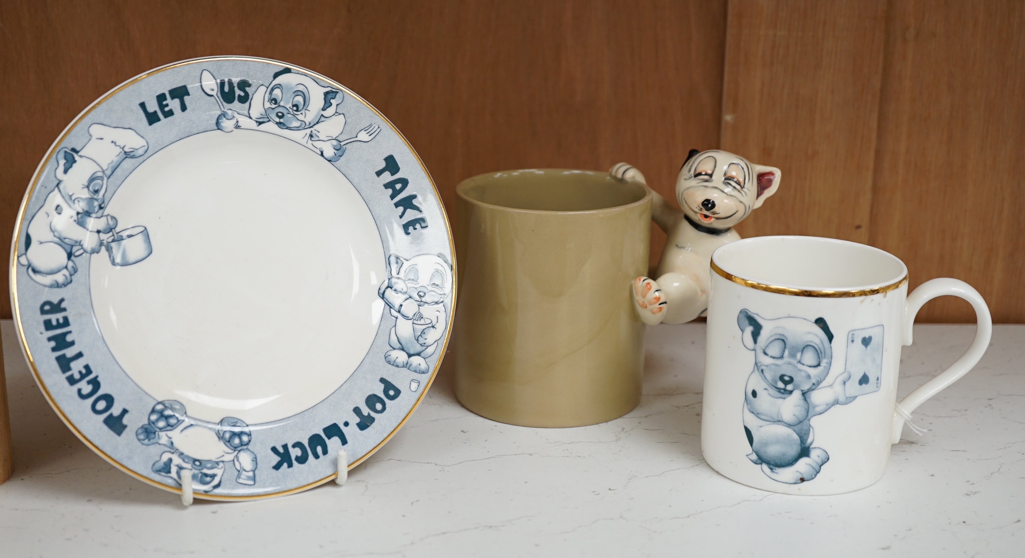 A Richard Dennis Bonzo Dog mug and matching plate and a Dennis China glazed pottery mug, plate 17cm diameter (3). Condition - slight chip to base edge of plate